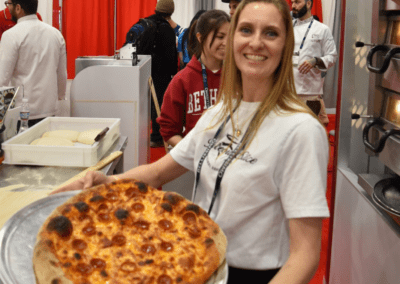 Cheryl Crawford holding her NY Artisan pizza