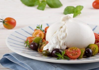 Burrata on a plate with tomatoes and basil