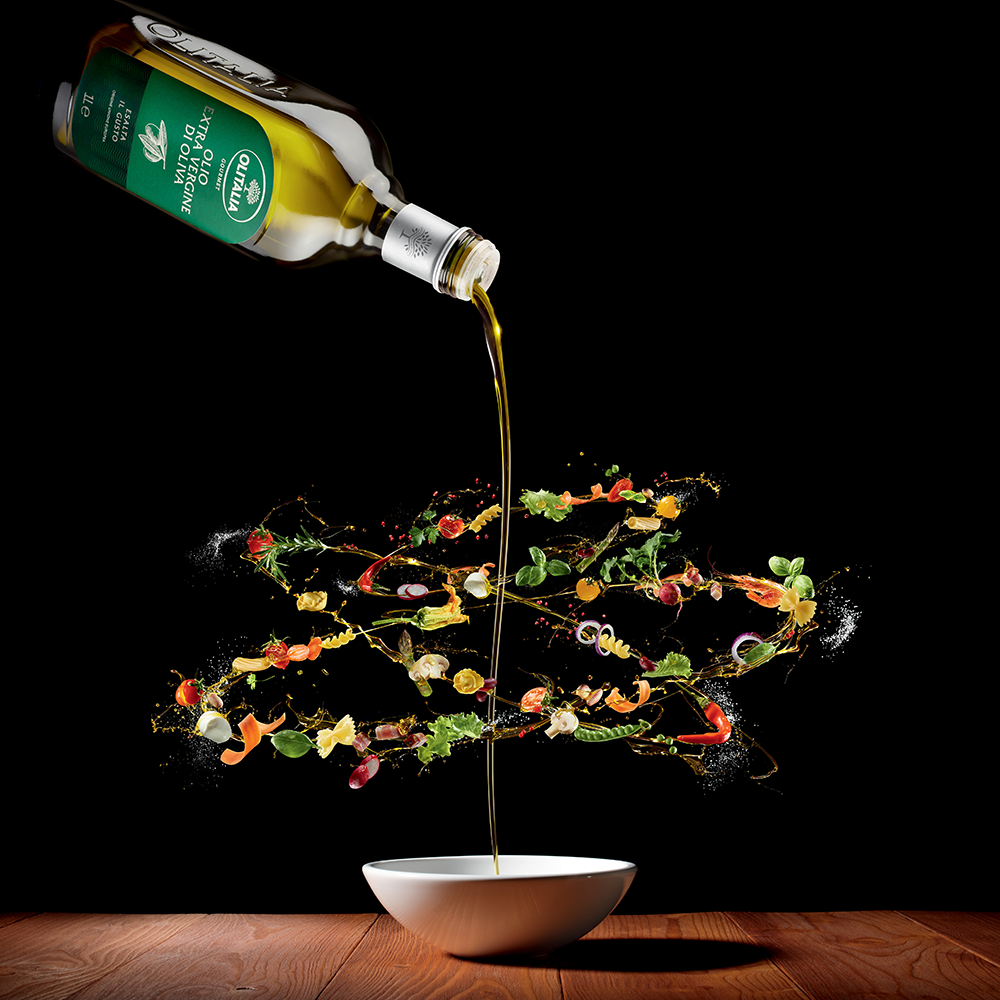 Olitalia EVOO being poured onto a salad