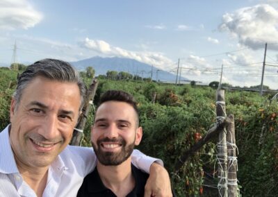 Fred Mortati and Antonio Spatuzzi, the head of production at Ciao, in a San Marzano field with Mt. Vesuvio behind them.